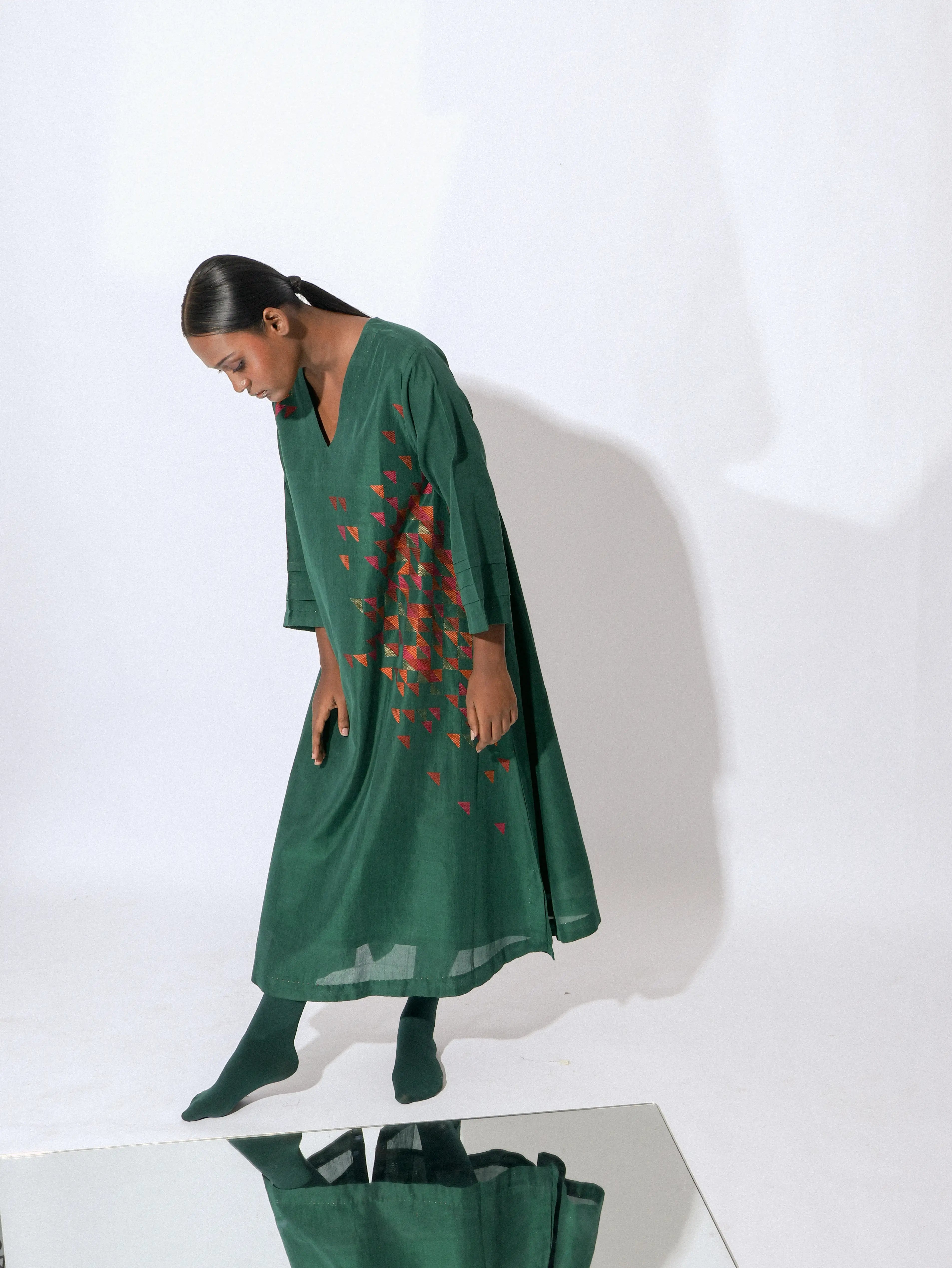 Stardust emerald V-neck A line dress Dress is a handwoven silk piece adorned with intricate Jamdani work.