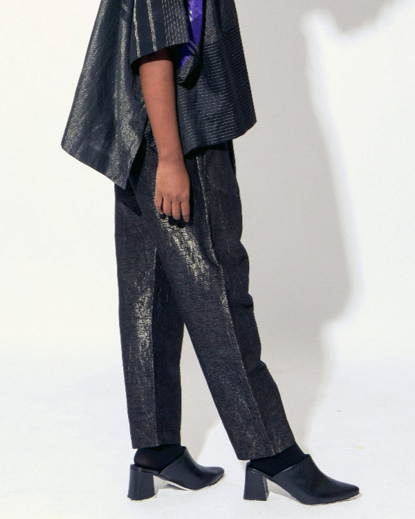 The Shoonyata Burnished Tissue Pants are crafted from silk tissue fabric with a subtle burnished finish, creating a soft shimmer. These relaxed-fit pants feature a gently tapered silhouette that combines comfort with contemporary style.