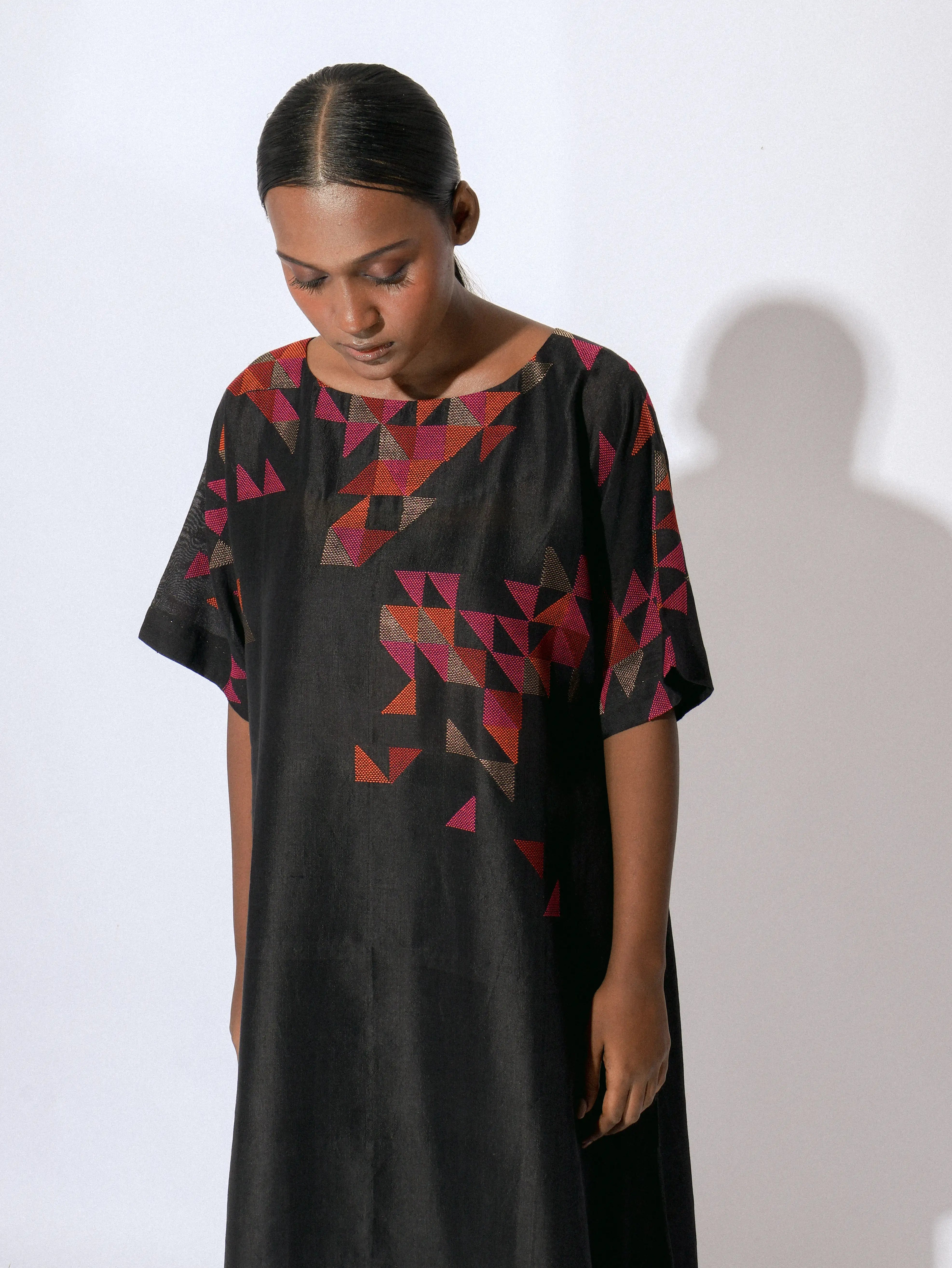 "The Onyx Boat-Neck Dress is a handwoven silk piece adorned with intricate Jamdani work."