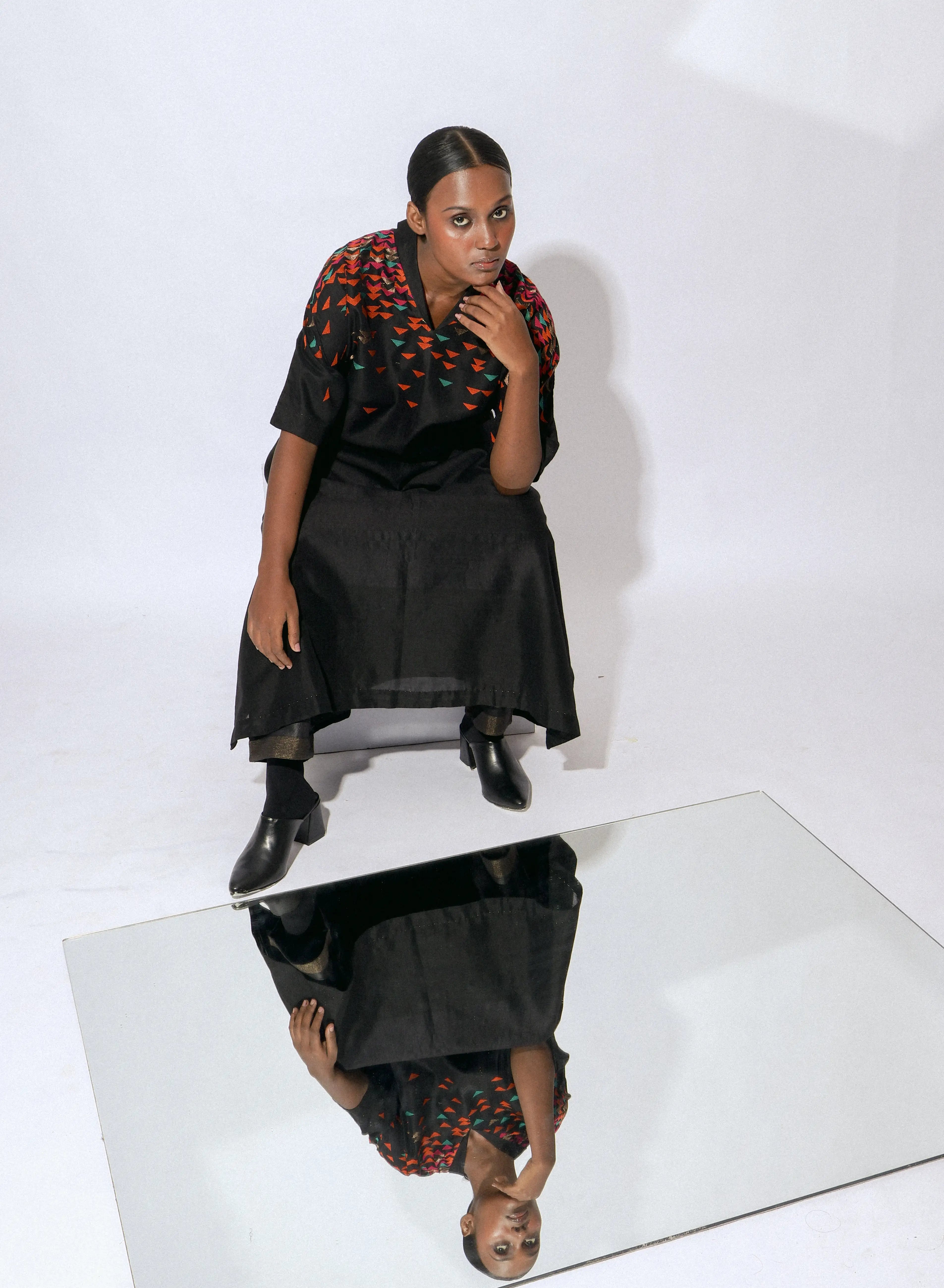 "The Onyx Shawl-collar-A-line Dress is a handwoven silk piece adorned with intricate Jamdani work."